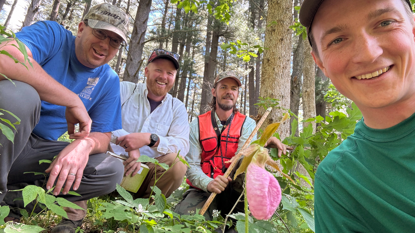 Grant Fessler with the slipper-shaped blossom search team